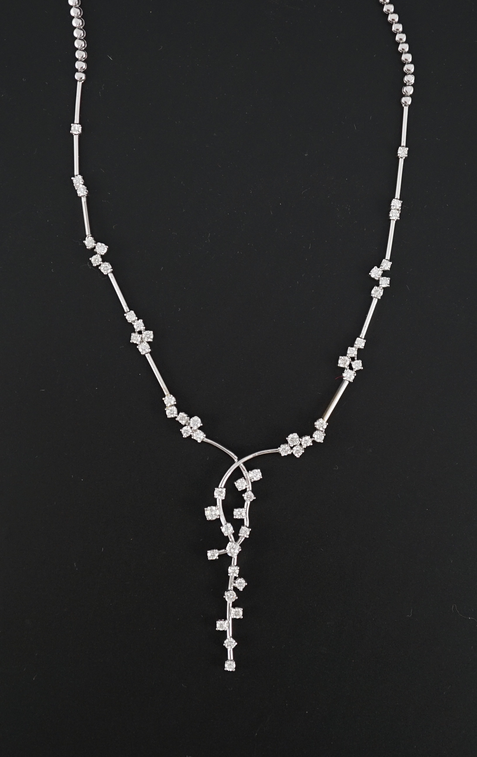 A modern 18k white gold and diamond cluster set necklace